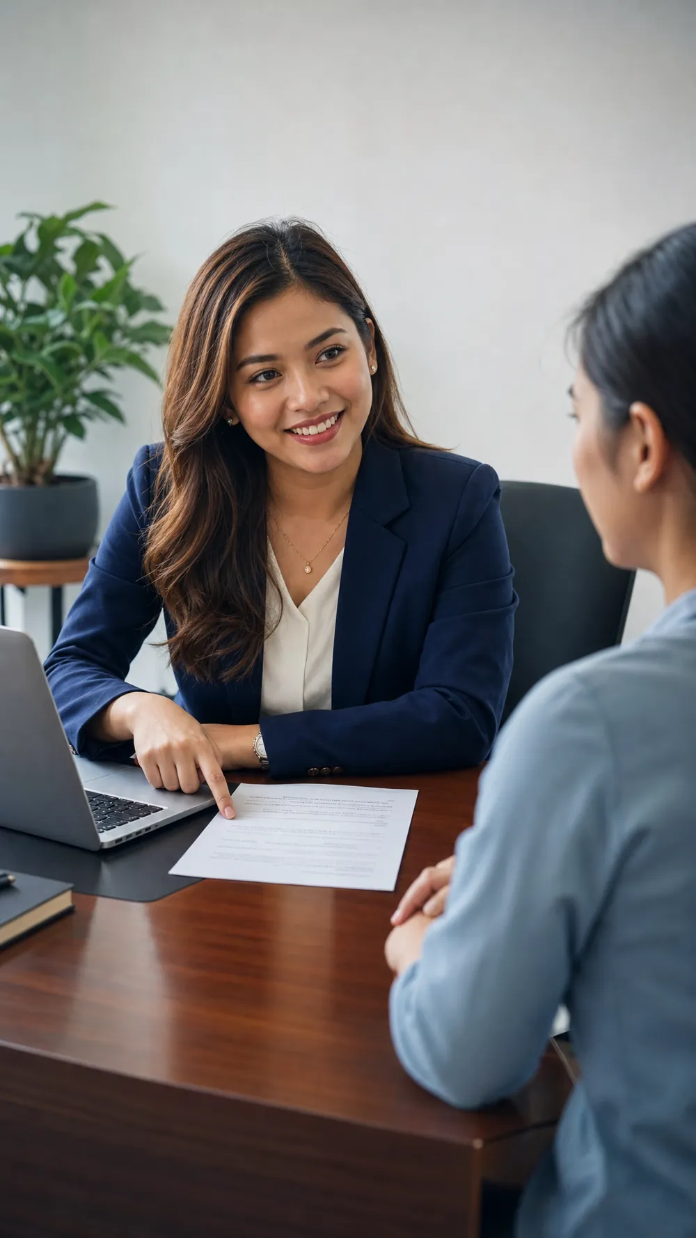 A NextPage Careers consultant reviewing a visa document with a client across a desk